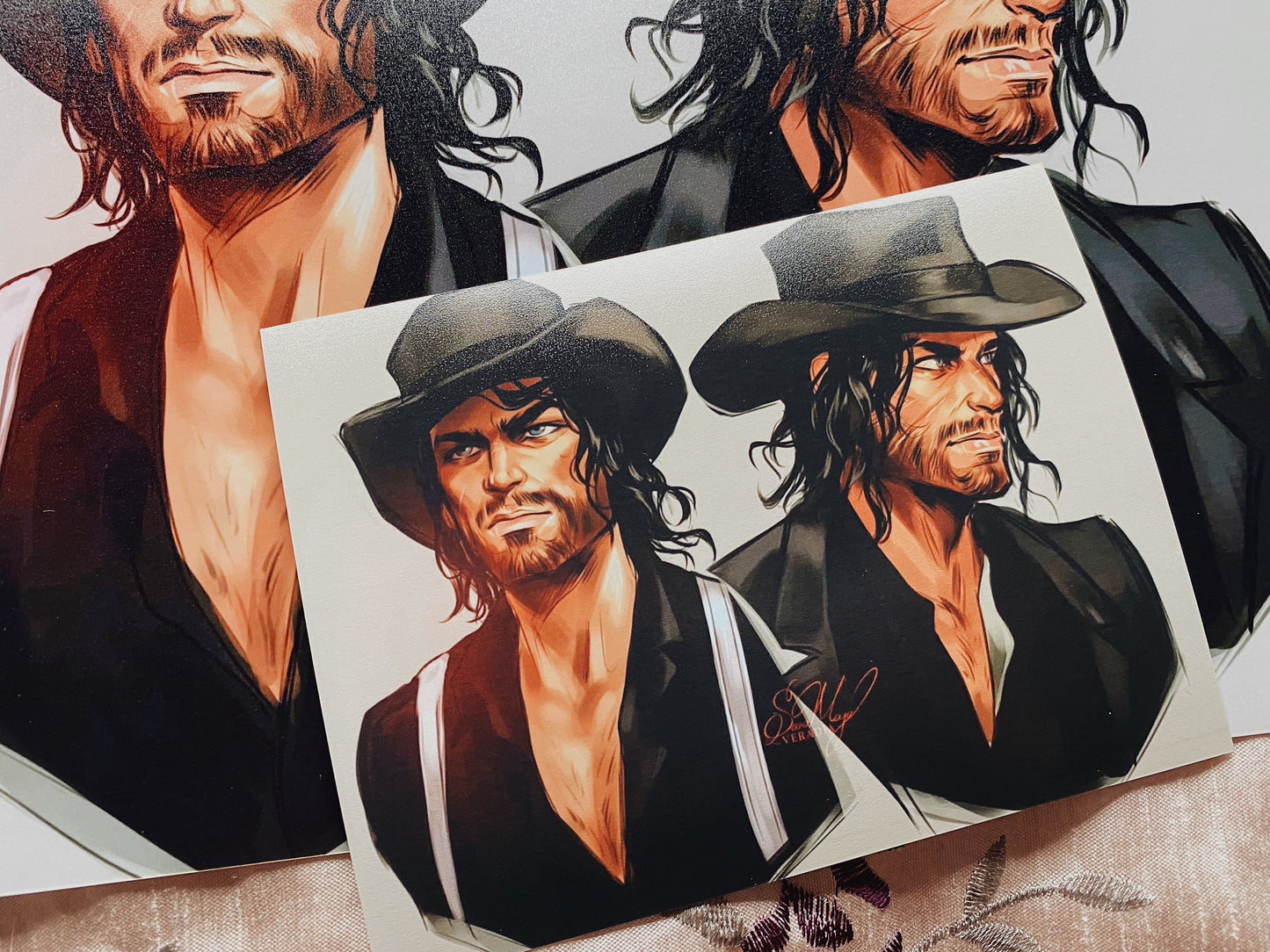 Cowboy art sketches in two sizes, showing the dark cowboy hat and top